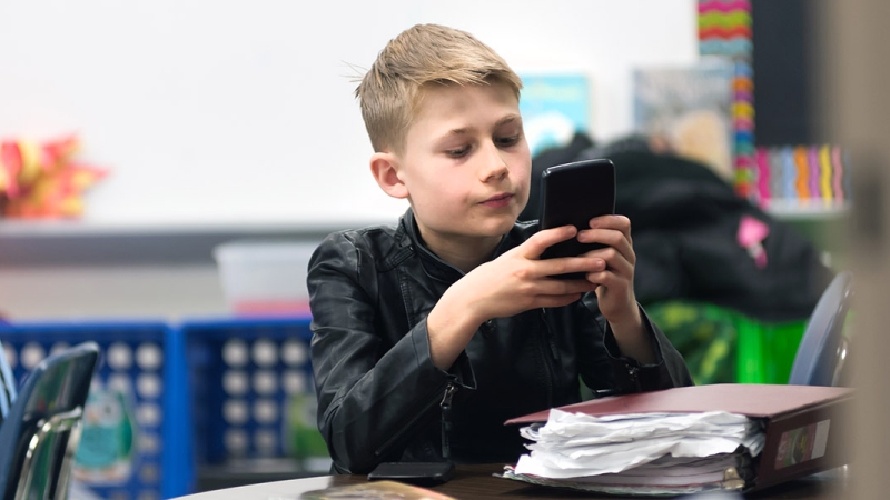 a photo of a student with an electronic device