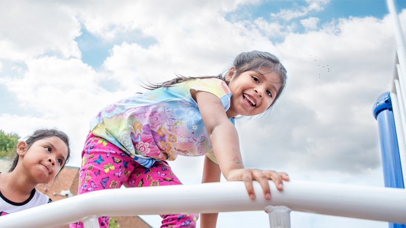 Student on playground equipment.