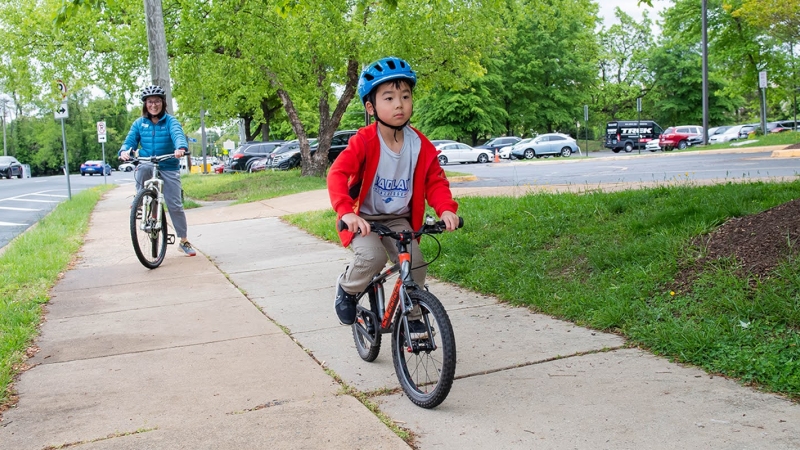 student rides a bike