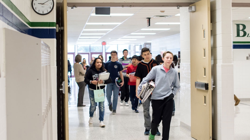 Photo of students entering a school building