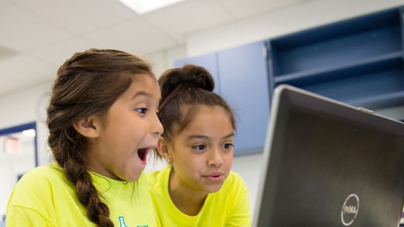 two students looking at laptop