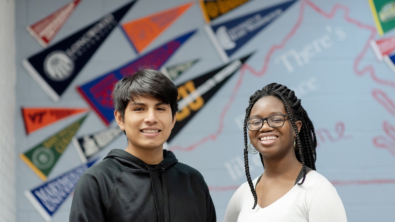 students in counseling office with college pennants behind them