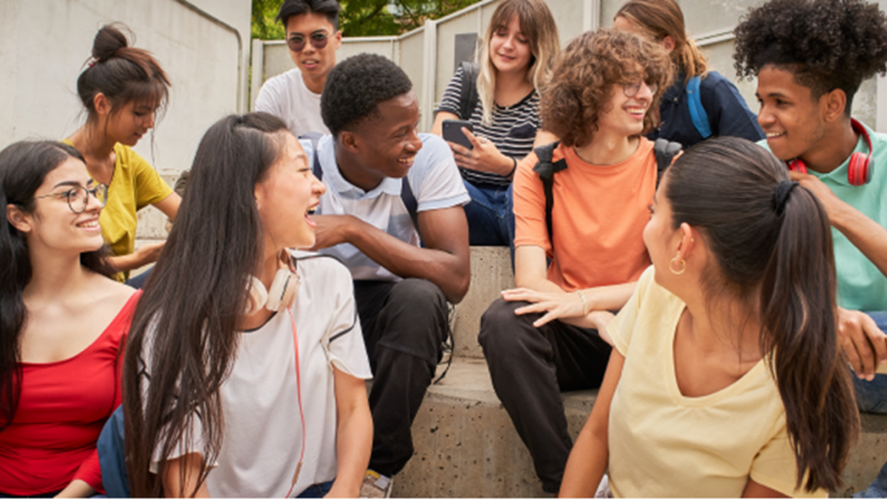 Students sitting on a step outside