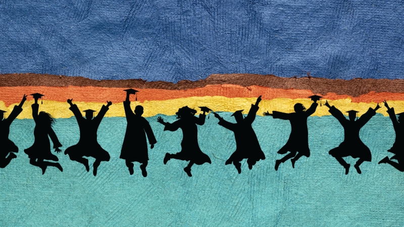 Silhouettes of graduates jumping.