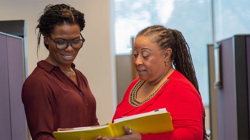 two employees reviewing a document