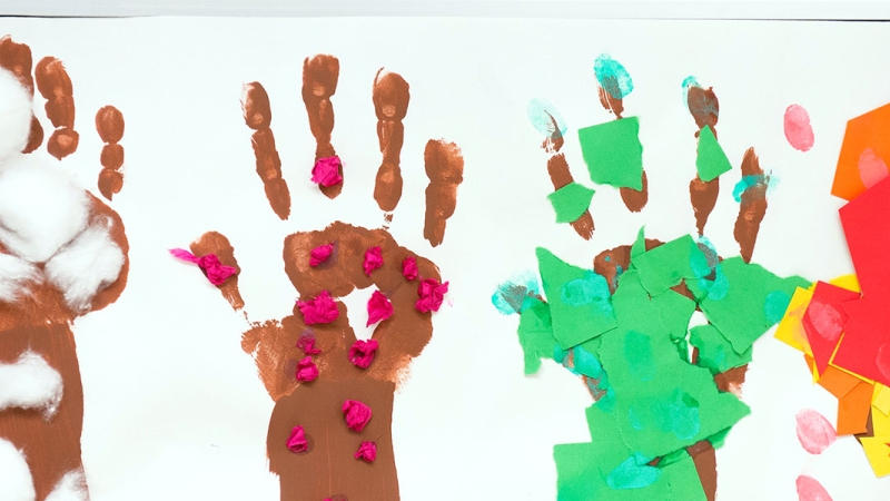 Photo of student artwork of different colored handprints