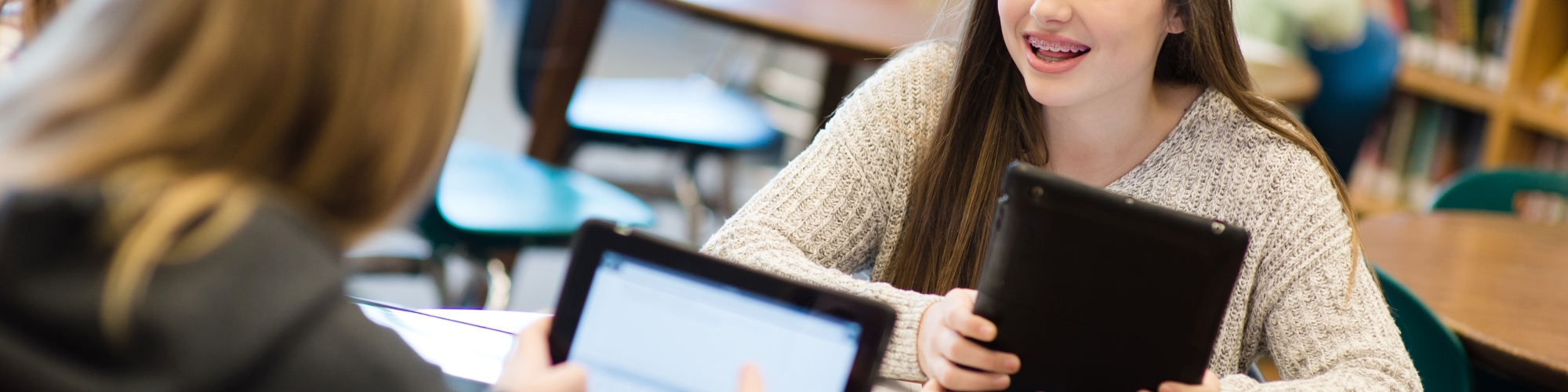 photo of two students in a library