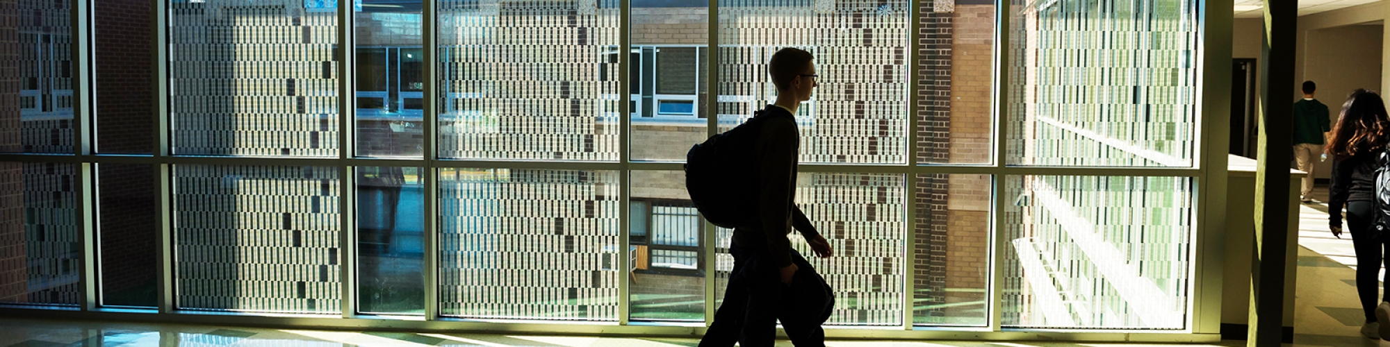 student walking in a hallway