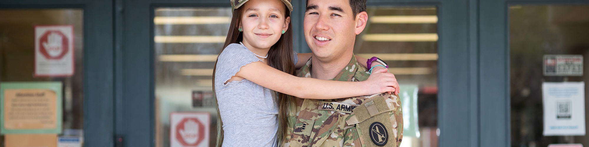 Dad in military uniform with daughter