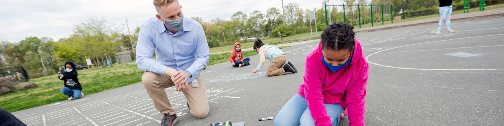 Student and teacher on school blacktop.