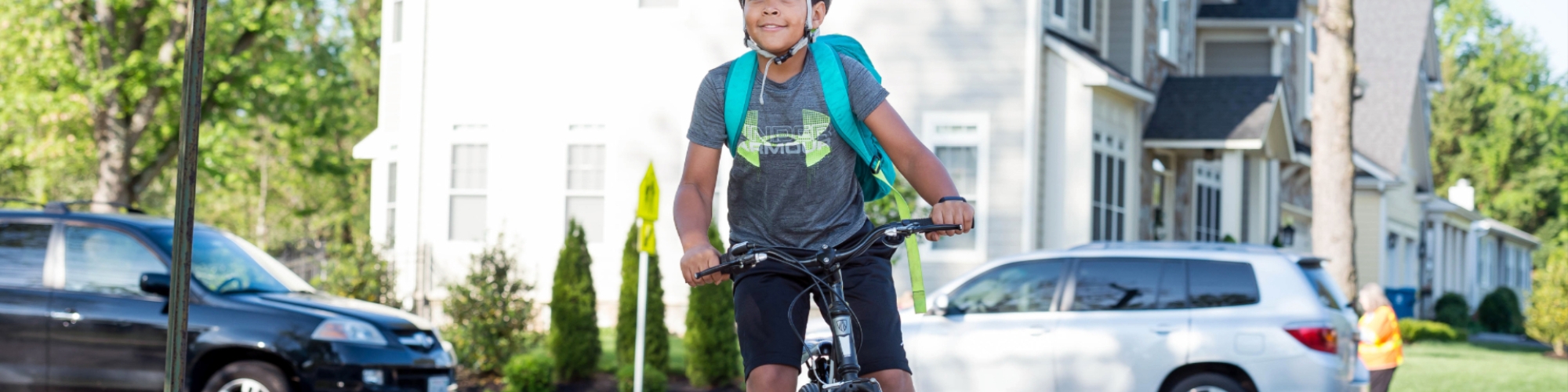 Male student riding a bike to school