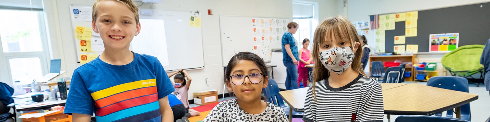 Three students smiling.