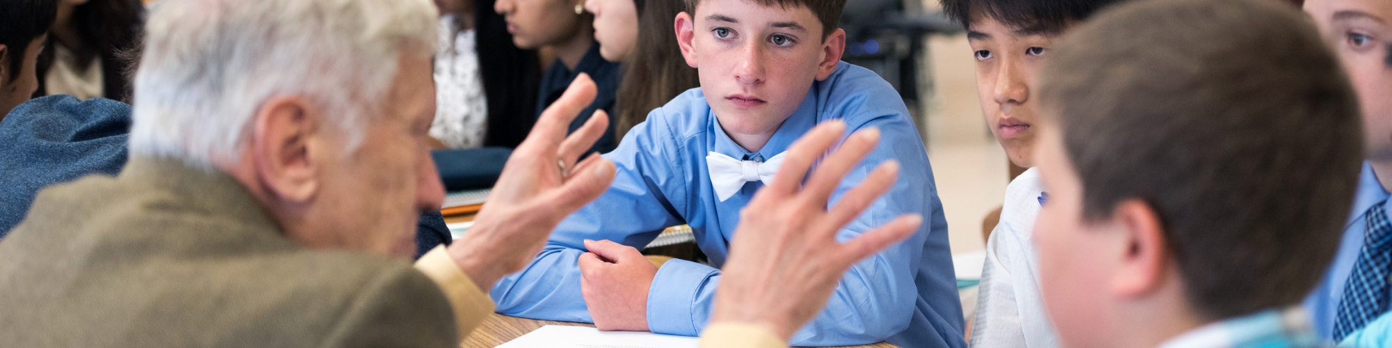 man talking to students