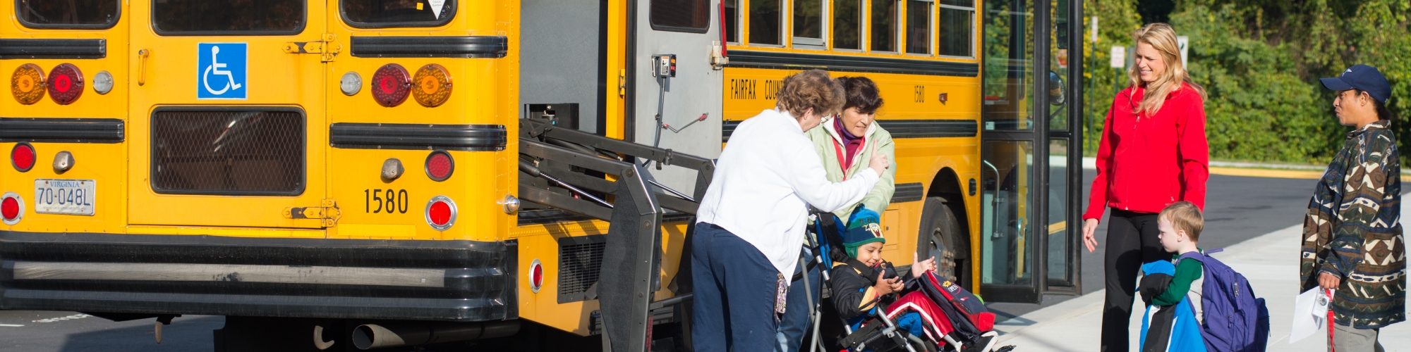 Special needs students being helped off bus