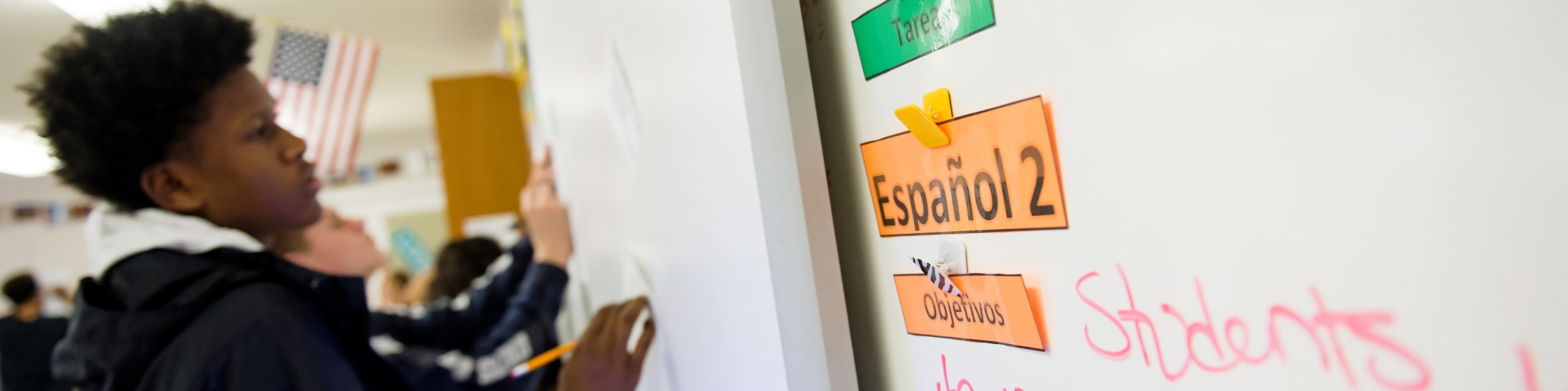 student working on language studies on a white board.