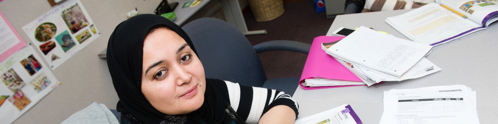 photo of a student at a table looking at the camera