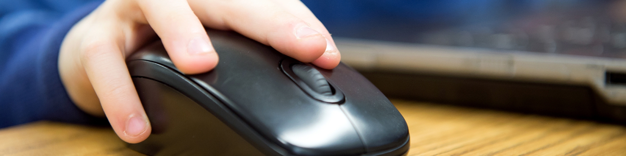 photo of a child's hand on an external computer mouse