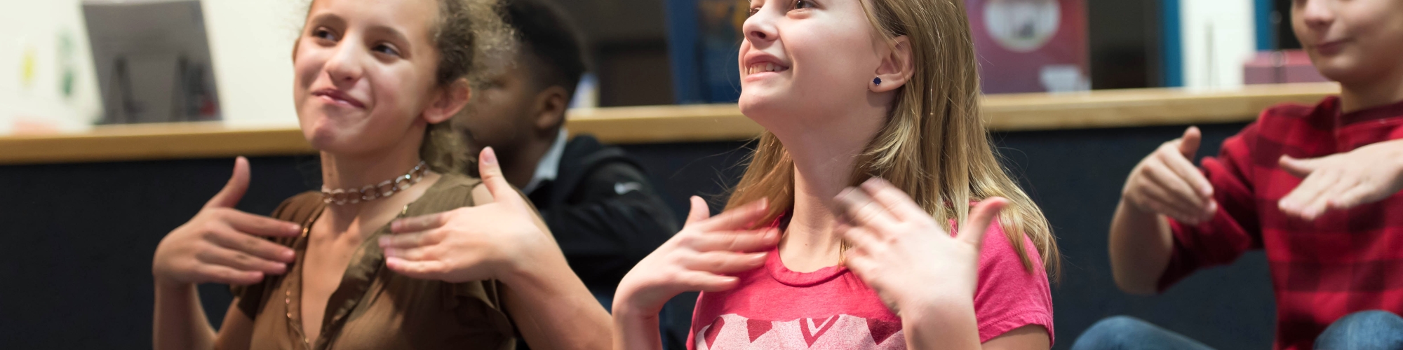 Photo of two female students signing