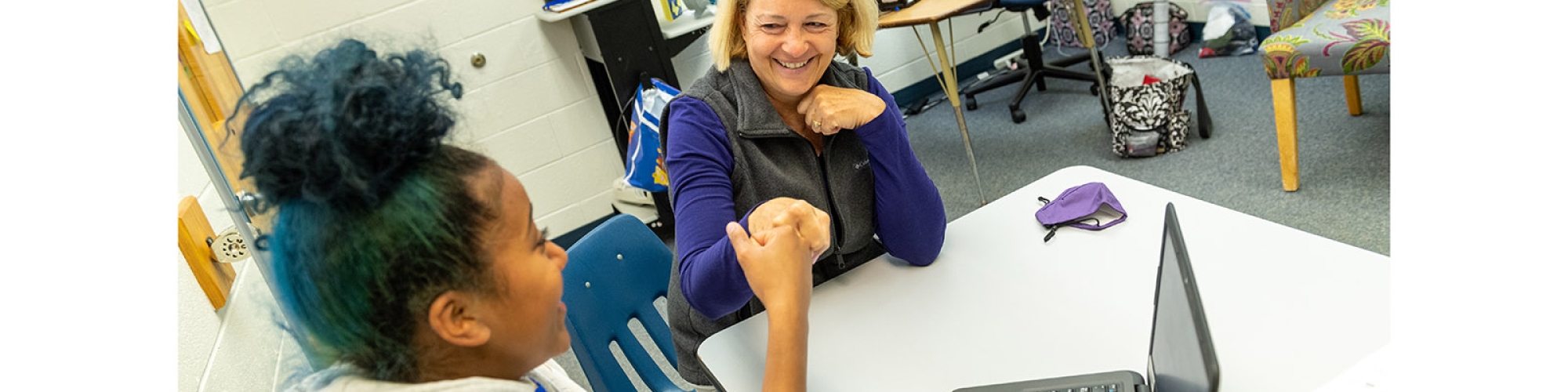 a teacher helping a student