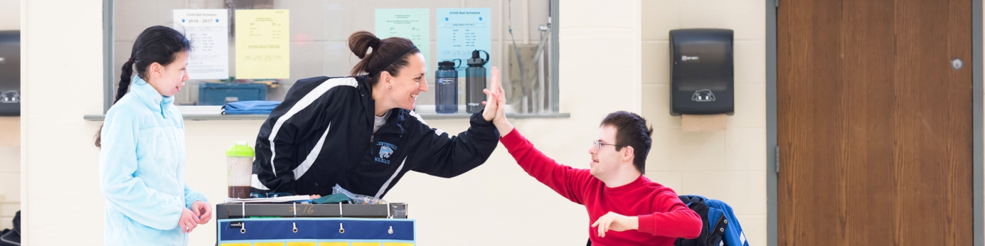 Photo of student giving teacher a high five