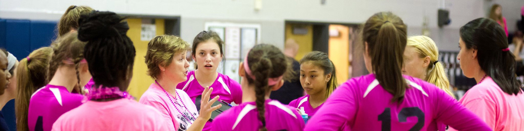 coach meeting with girls volleyball team