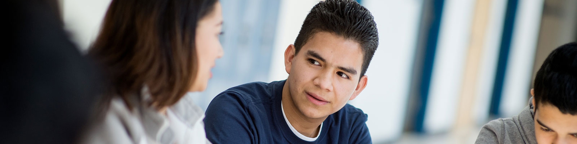 Photo of a student talking with a teacher