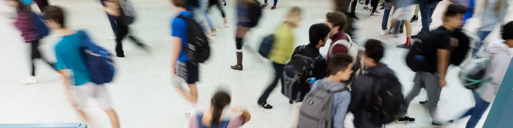 Blurred view of students walking in a school hallway