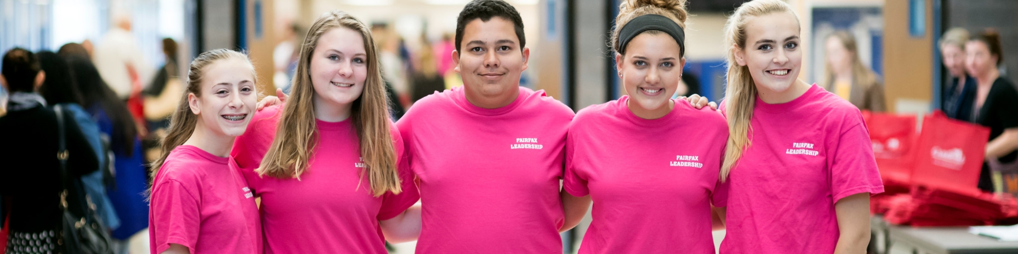 Five students wearing pink shirts