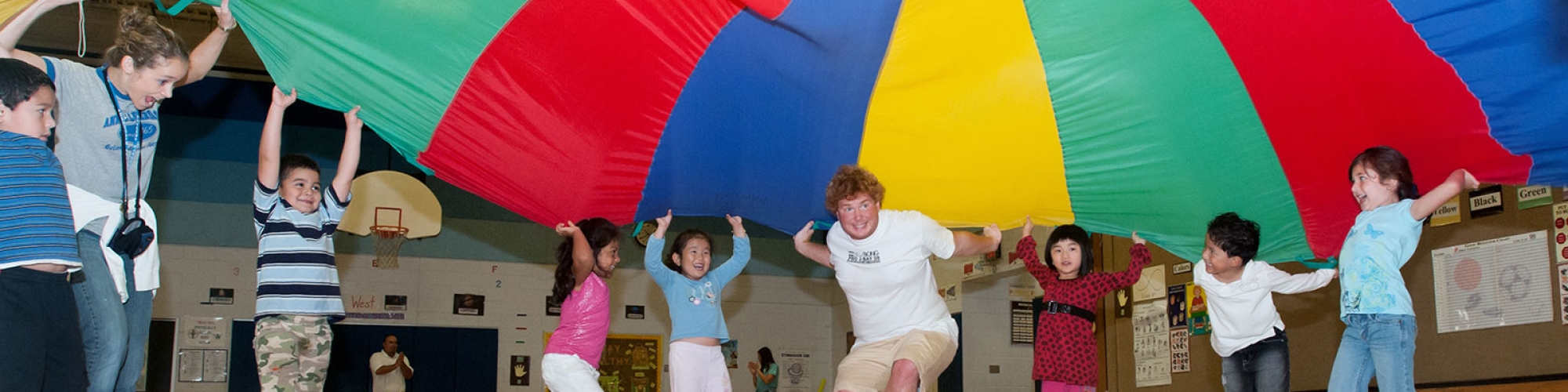 Students with a parachute in physical education class