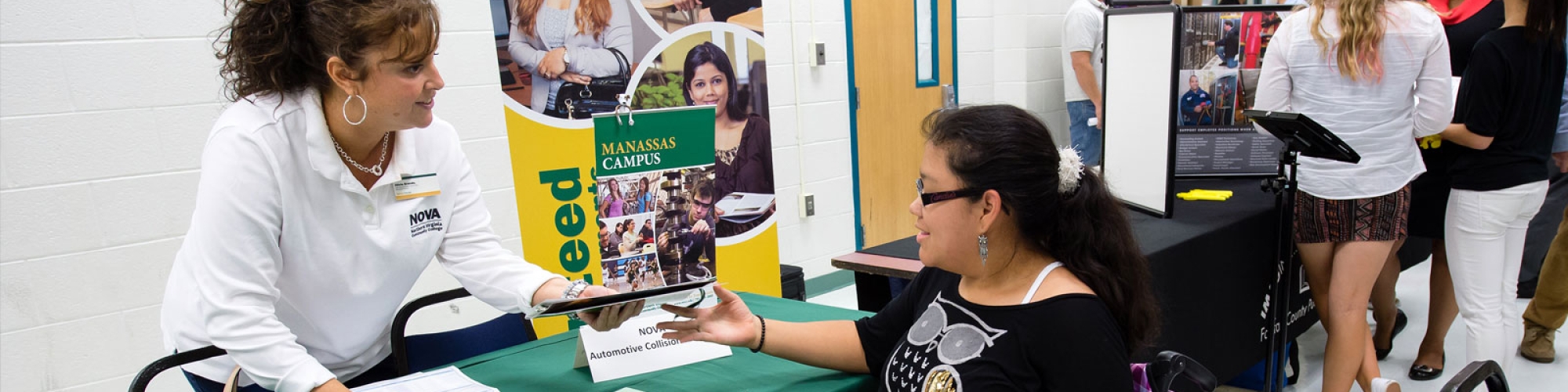 a student at a career fair interacting with an adult