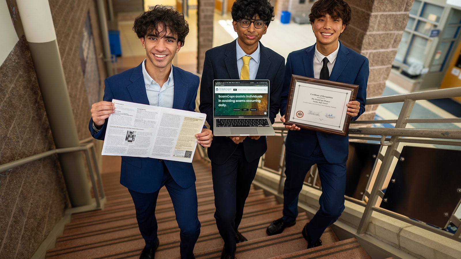 three high school students holding certificates