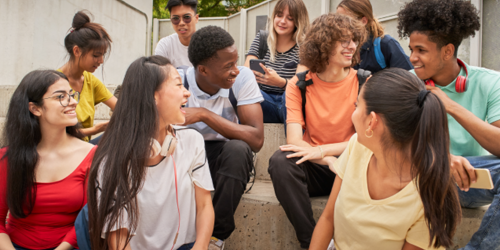 Students sitting on steps outside.