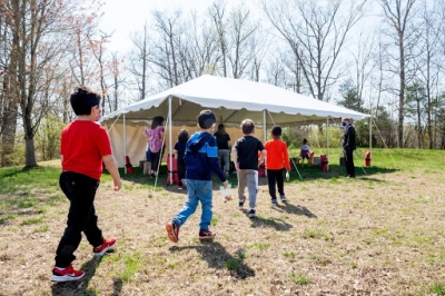 students walking towards a tent